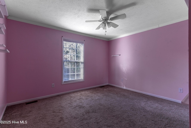 empty room featuring a textured ceiling, carpet floors, ceiling fan, and crown molding