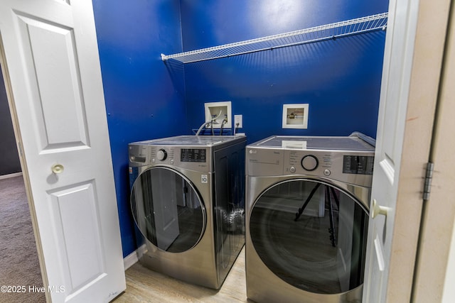 clothes washing area featuring washer and clothes dryer