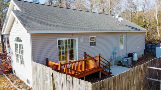 rear view of property with central AC unit and a deck