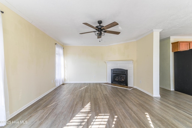 unfurnished living room featuring a textured ceiling, light hardwood / wood-style flooring, ceiling fan, and ornamental molding