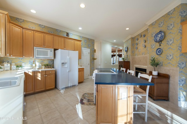 kitchen featuring a breakfast bar, white appliances, sink, ornamental molding, and a kitchen island