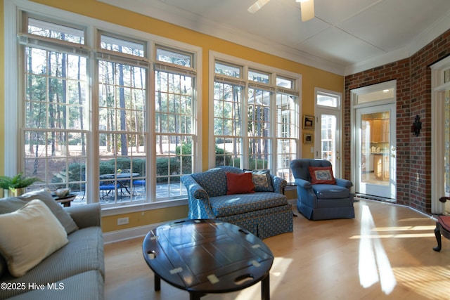 sunroom / solarium featuring ceiling fan