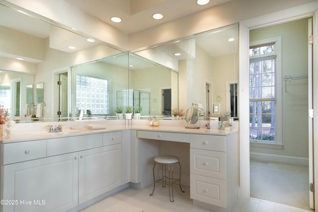 bathroom featuring vanity and a shower with shower door