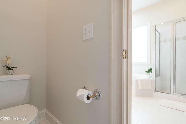 bathroom with a shower with door and toilet