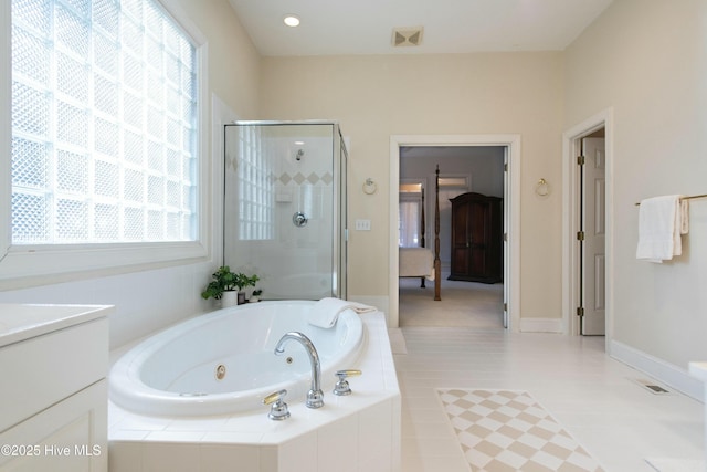 bathroom with tile patterned floors, vanity, separate shower and tub, and a wealth of natural light