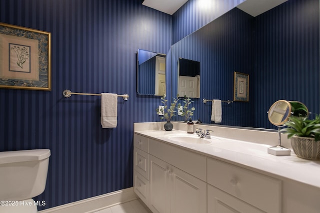 bathroom with tile patterned floors, vanity, and toilet