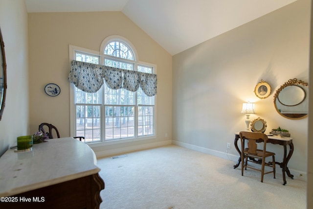 carpeted home office with high vaulted ceiling