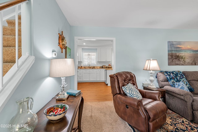 living room featuring light hardwood / wood-style flooring and sink