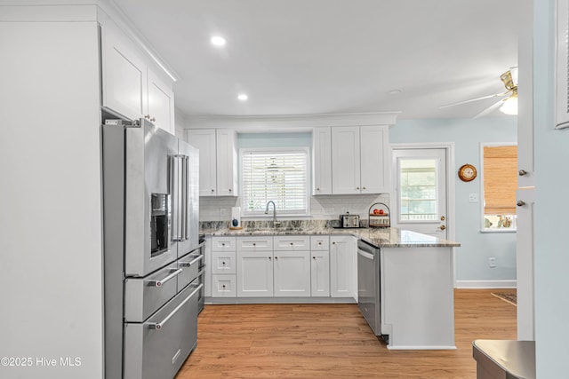 kitchen with white cabinets, appliances with stainless steel finishes, and sink