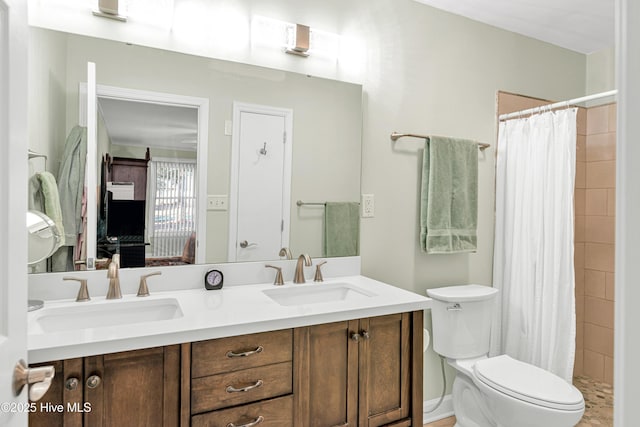 bathroom featuring toilet, vanity, and a shower with shower curtain