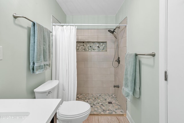 bathroom featuring walk in shower, vanity, and toilet