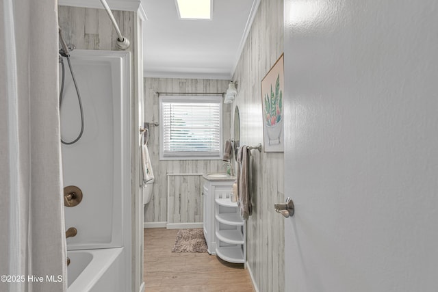 bathroom with bathtub / shower combination, ornamental molding, and hardwood / wood-style floors