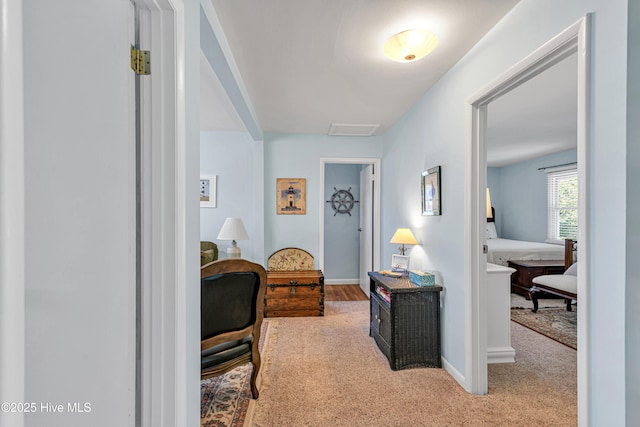 corridor featuring light colored carpet