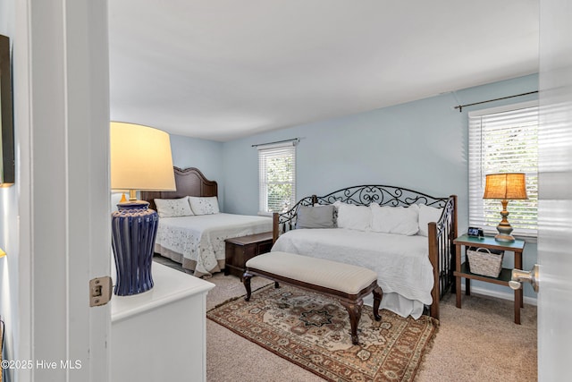 carpeted bedroom featuring multiple windows