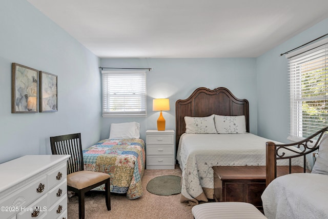 carpeted bedroom featuring multiple windows