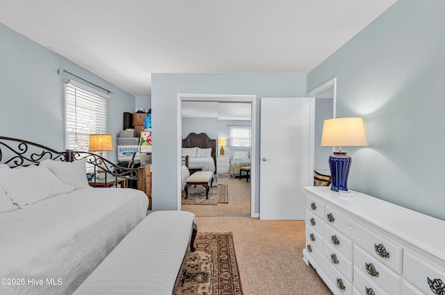 bedroom featuring a closet and light colored carpet