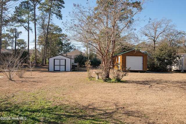 view of yard with a garage and a storage unit