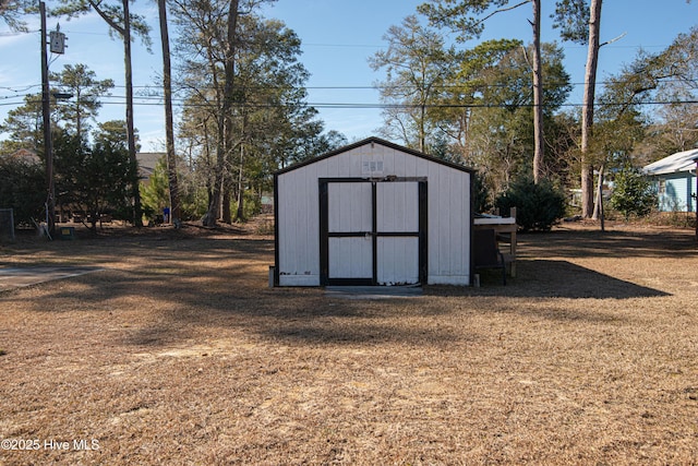 view of outdoor structure featuring a lawn