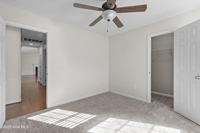 unfurnished bedroom with ceiling fan, a closet, and carpet floors