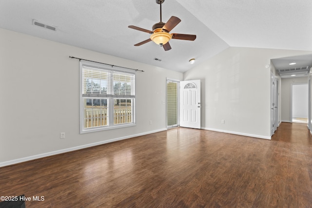 unfurnished room with ceiling fan, a textured ceiling, dark hardwood / wood-style flooring, and lofted ceiling