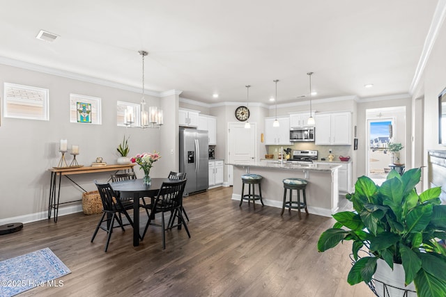 dining area with a chandelier, crown molding, and dark wood-type flooring