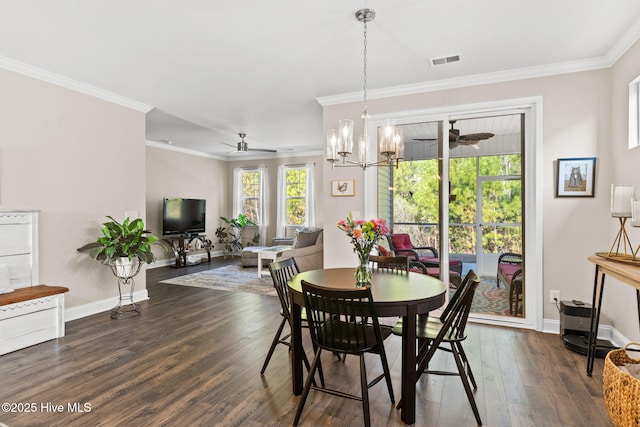 dining space featuring ceiling fan with notable chandelier, crown molding, and dark wood-type flooring