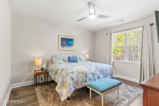 bedroom with ceiling fan and dark hardwood / wood-style flooring