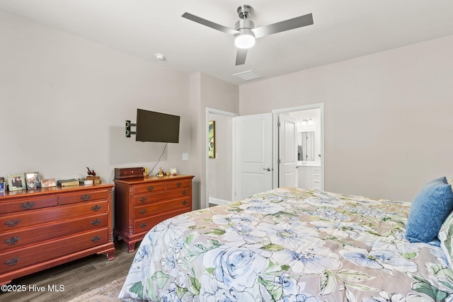 bedroom with connected bathroom, ceiling fan, and dark wood-type flooring