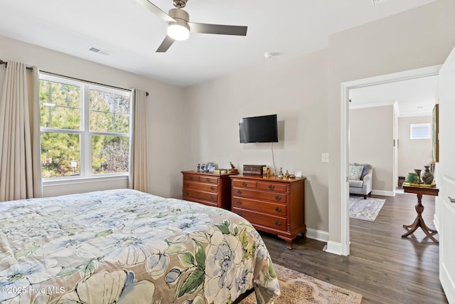 bedroom with ceiling fan and dark hardwood / wood-style flooring