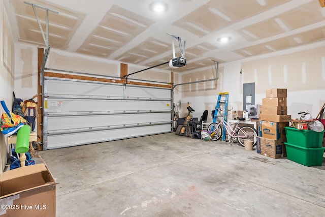 garage featuring electric panel and a garage door opener