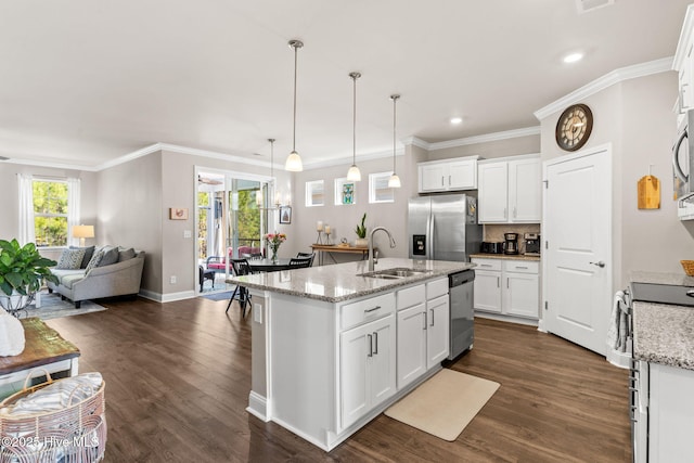 kitchen featuring sink, white cabinetry, decorative light fixtures, and appliances with stainless steel finishes