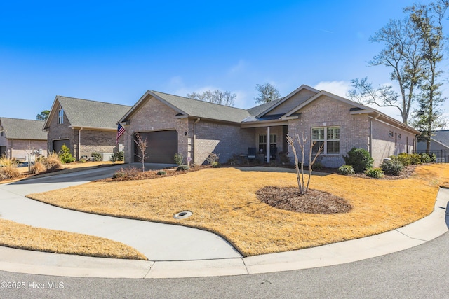 single story home with brick siding, concrete driveway, and an attached garage