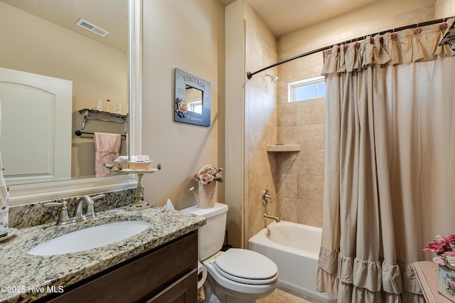 full bathroom featuring vanity, shower / tub combo with curtain, and toilet