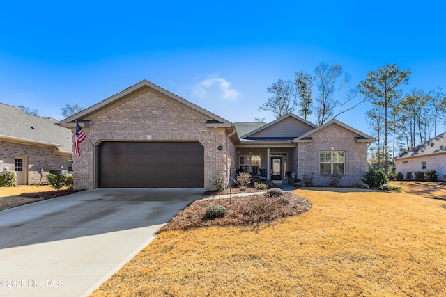 ranch-style house with brick siding, an attached garage, concrete driveway, and a front lawn