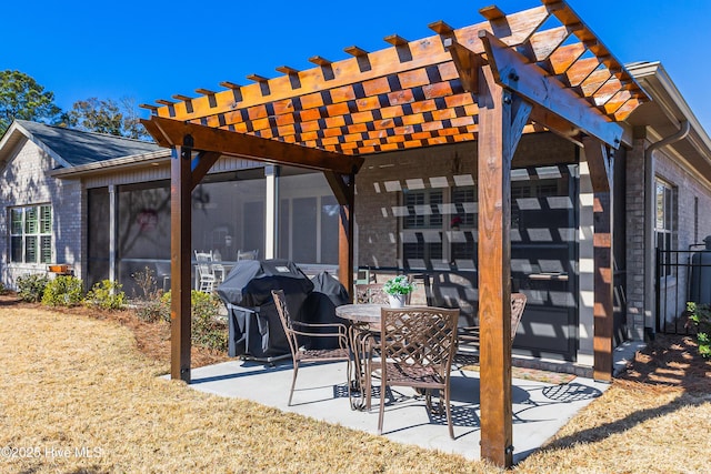 view of patio featuring grilling area, a pergola, and a sunroom