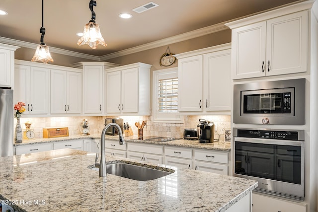 kitchen featuring pendant lighting, sink, crown molding, stainless steel appliances, and white cabinets