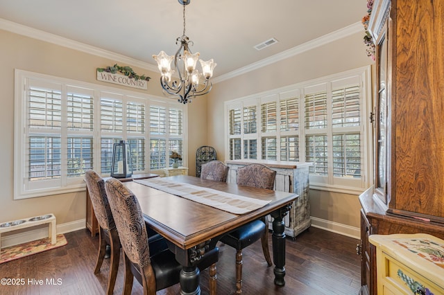 dining space with crown molding, dark wood-type flooring, and a chandelier