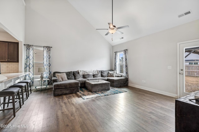 living room with a healthy amount of sunlight, high vaulted ceiling, ceiling fan, and wood-type flooring