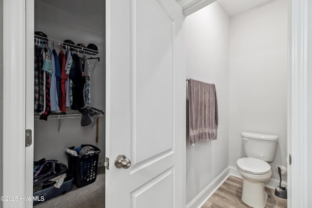 bathroom featuring toilet and hardwood / wood-style flooring