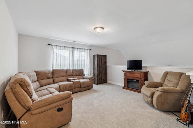 living room with light colored carpet and vaulted ceiling