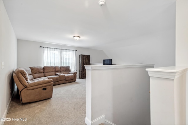 carpeted living room with lofted ceiling