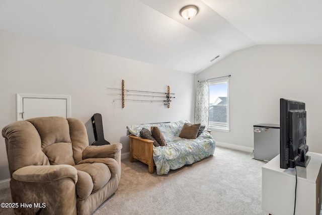 carpeted living room featuring vaulted ceiling