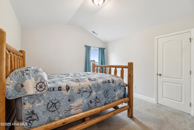 carpeted bedroom with vaulted ceiling