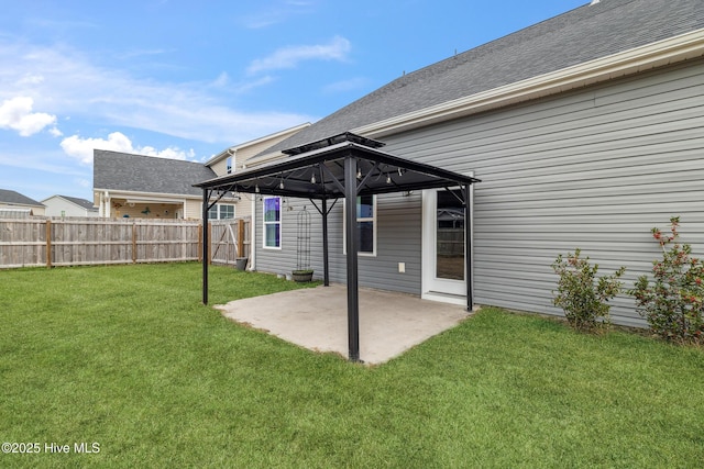 back of property featuring a lawn, a gazebo, and a patio area