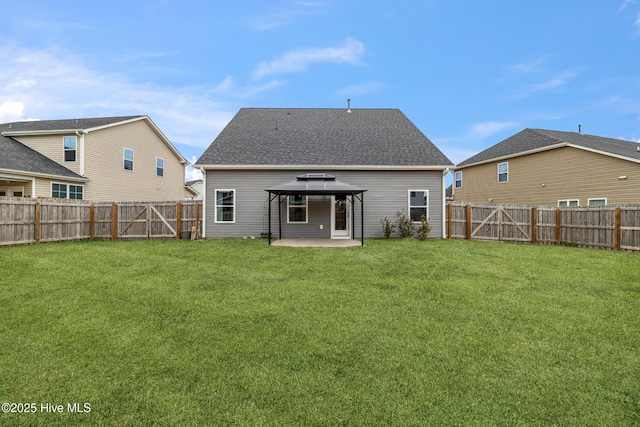 back of property with a patio, a yard, and a gazebo