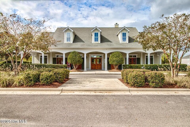 new england style home with french doors