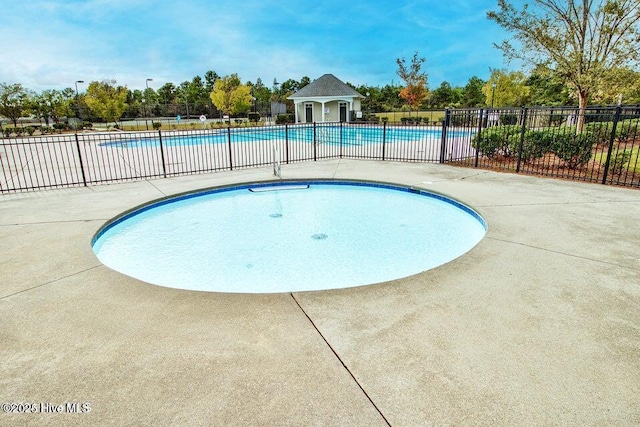 view of swimming pool featuring a patio area