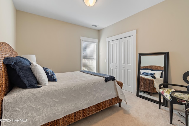 bedroom with a closet and light carpet