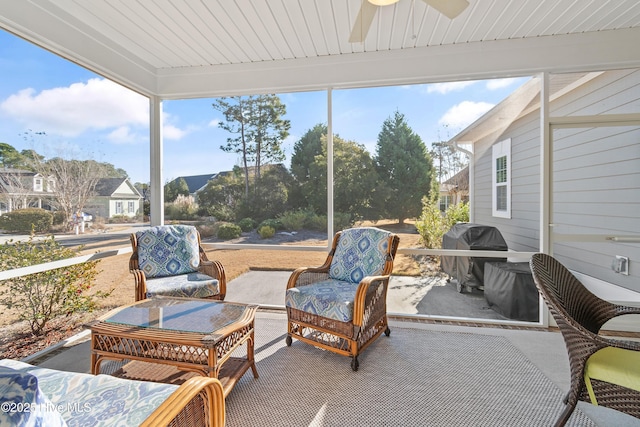 sunroom / solarium featuring ceiling fan