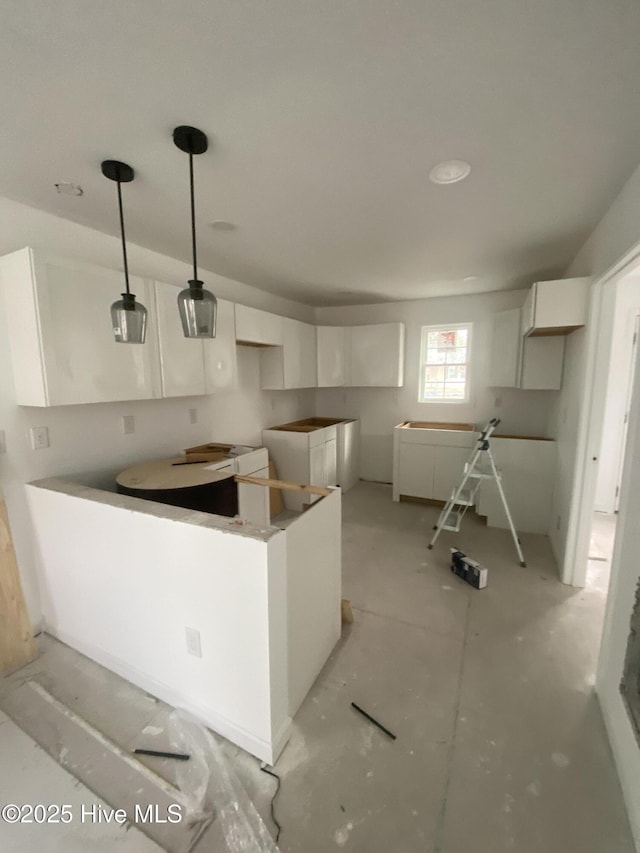 kitchen featuring white cabinets and decorative light fixtures